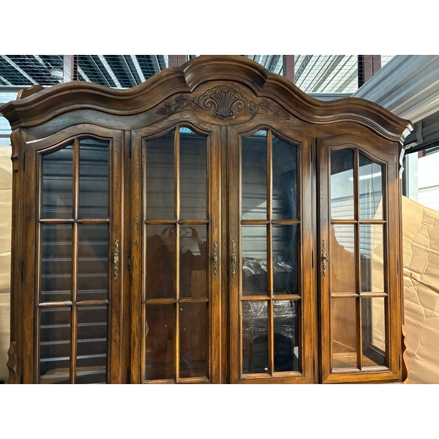 Experience the timeless allure of the French countryside with this exquisite china cabinet from the coveted Brittany...