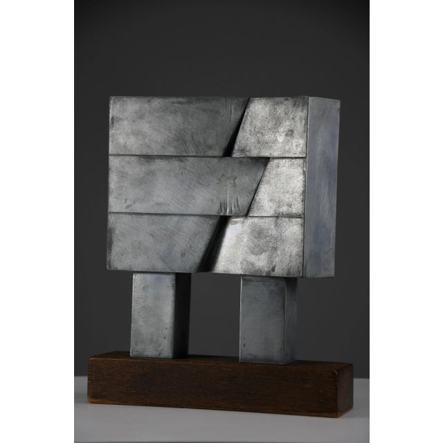 Chris verbeek, “gebroken i (broken i),” zinc and wood, the netherlands, 1977 dimensions: h. 27 cm (10.63 in.) x w. 22.5 cm...