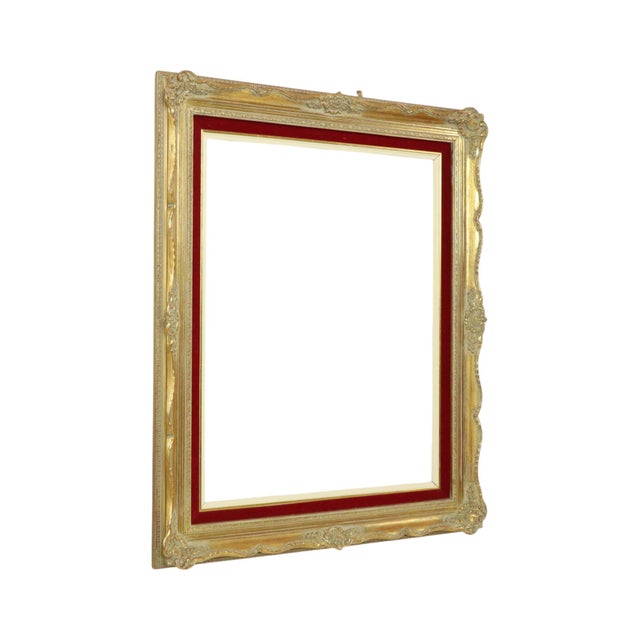 Large vintage gilded pine frame featuring an inner red velvet border; designed in a classic Baroque style and adorned with...