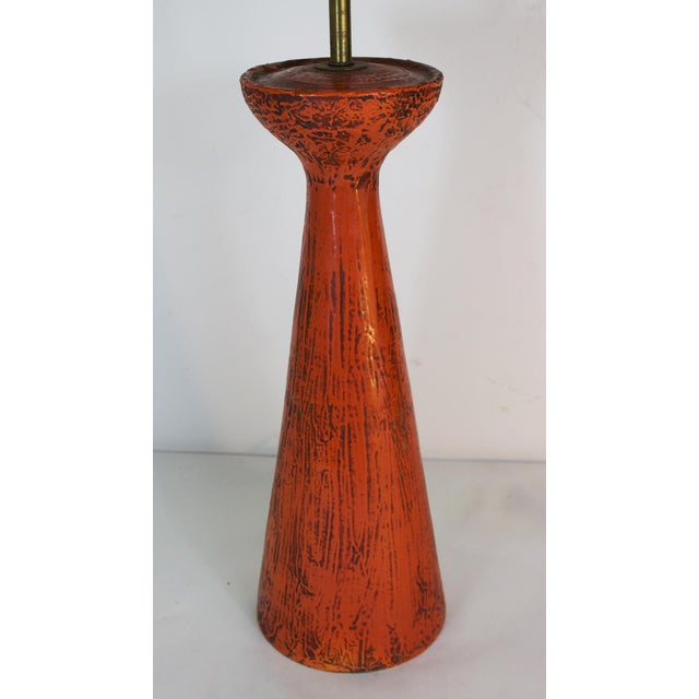 Tall mid 20th century ceramic pottery table lamp by Bitossi. Pumpkin orange color with a "rough" surface that suggests...