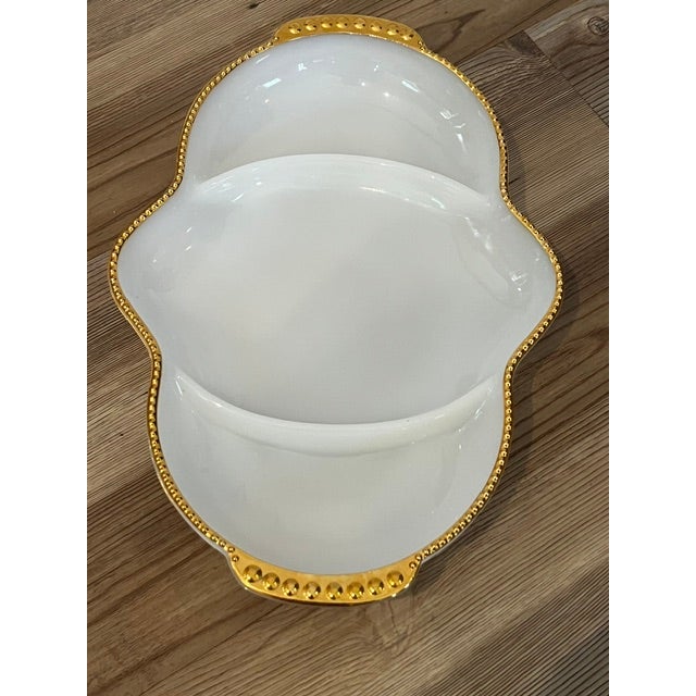 This vintage relish dish is made by Fire-King (Anchor Hocking) from white milk glass.It features three divided sections...