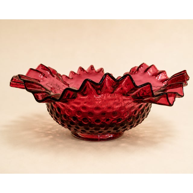 Add a touch of elegance to your home with this Vintage Cranberry Hobnail Art Glass Ruffled Bowl, beautifully crafted in...