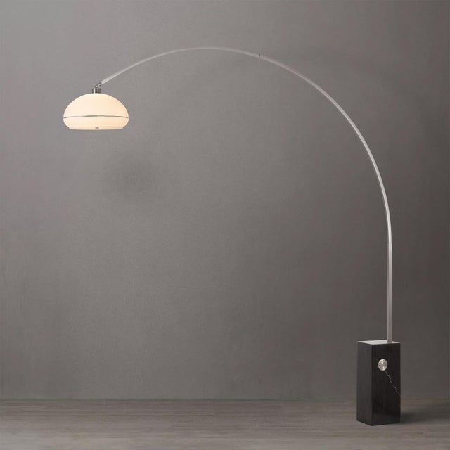 Constructed from satin nickel steel with a black marble base, the Iconic Arc Lamp is a mid-century modern masterpiece....