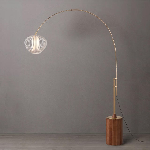 The Tambo Arc Lamp is a dimmable arc lamp featuring a weathered brass steel body and a sphere white satin steel shade,...