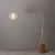 The Tambo Arc Lamp is a dimmable arc lamp featuring a weathered brass steel body and a sphere white satin steel shade,...