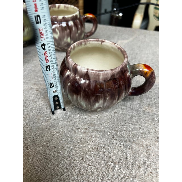 Up for consideration is a beautiful vintage collection of purple pottery mugs. These would look lovely in your home and...