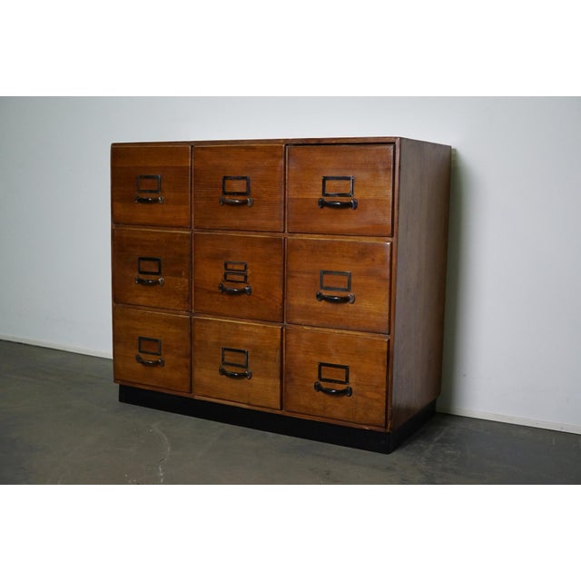 This apothecary cabinet was produced during the 1950s in Germany. This piece features 9 large drawers with nice metal...