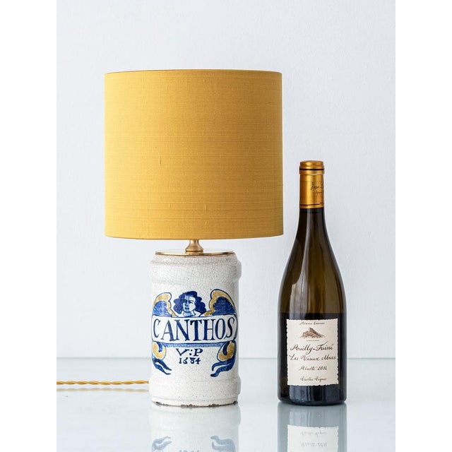 This unique table lamp, named Canthos, has been meticulously handcrafted from a 19th-century Italian albarello—an...