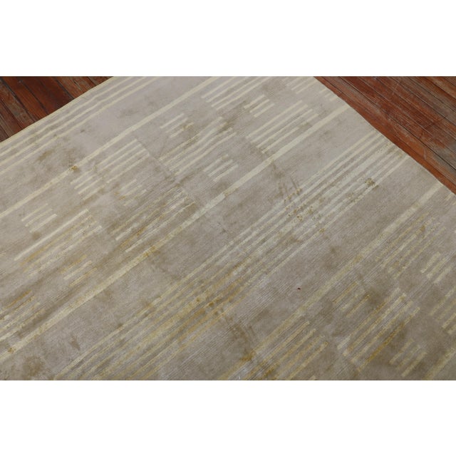 Late 20th century part silk part wool Tibetan carpet in warm brown and gold hues. Measures: 11'9" x 14'10".