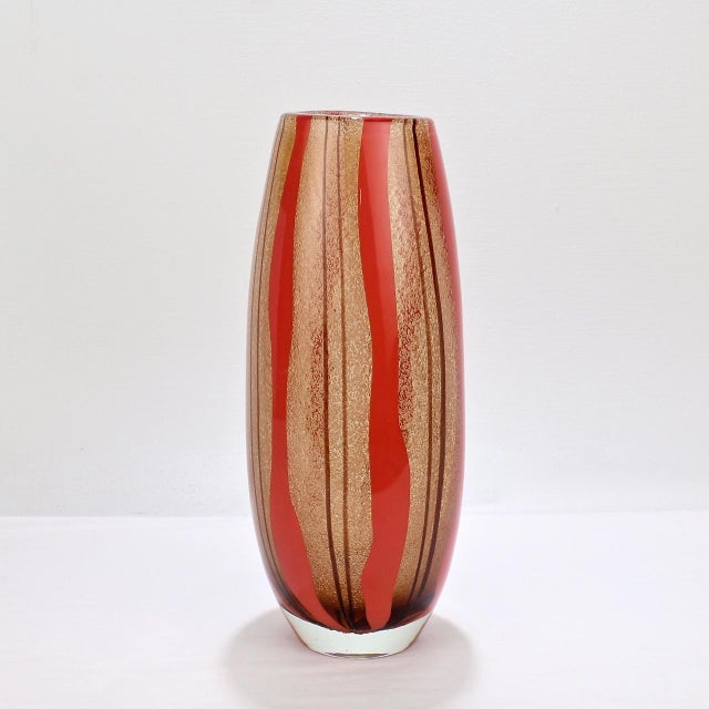 A good Murano glass vase with red and purple stripes. In the style of Flavio Poli with a thick body, bullicine and 'a...