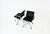 Set of two black leather armchairs with aluminum bases and wheels. Swivels. Armchair dimensions: Seat height 51 cm....
