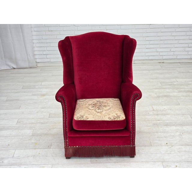 1970s, Danish highback armchair. Original red furniture velour, ash wood legs, brass springs in the seat cushion. Double...