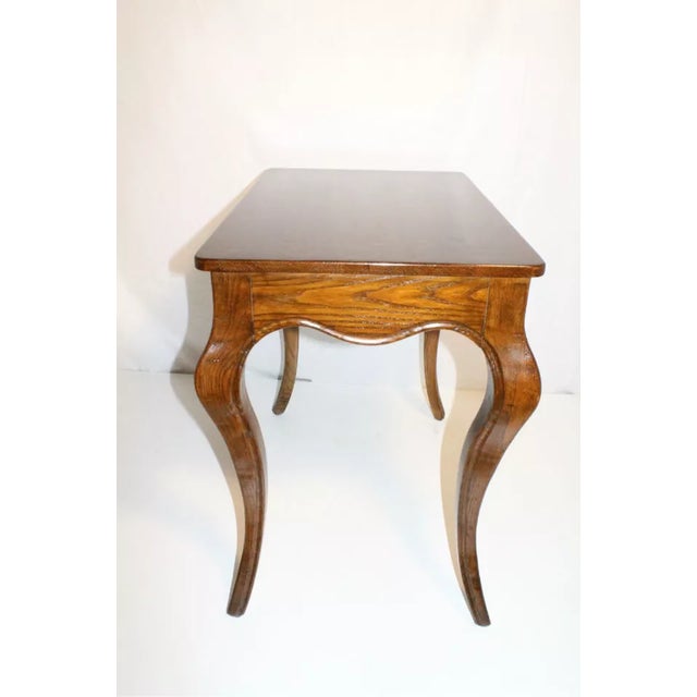 Magnificent French Provincial oak side table circa 1920's, features a rectangular top above a scalloped apron with a...