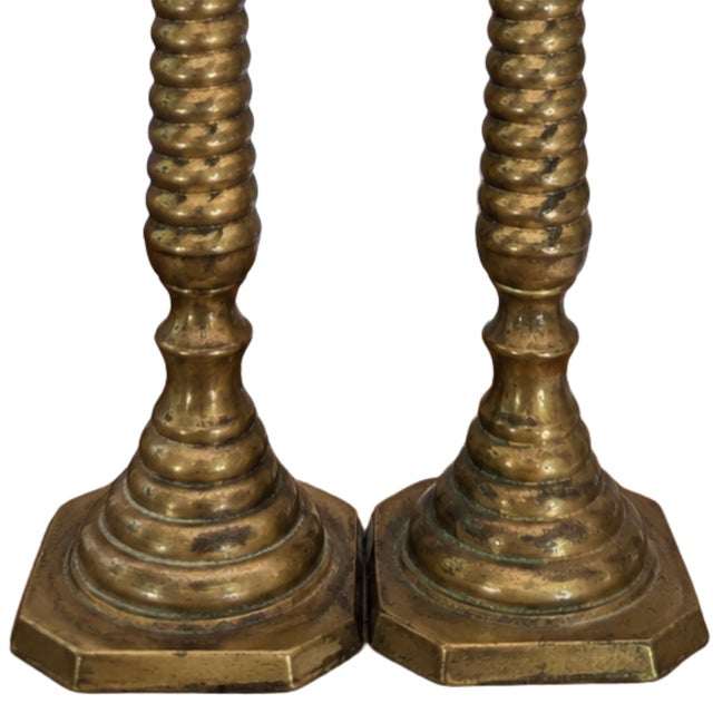 Add timeless warmth and classic elegance to your home with this beautiful pair of vintage solid brass candlestick holders....