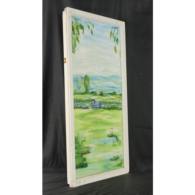 Original artwork painted on an old window pane depicting a garden scene with a stone wall and rolling hills in the...