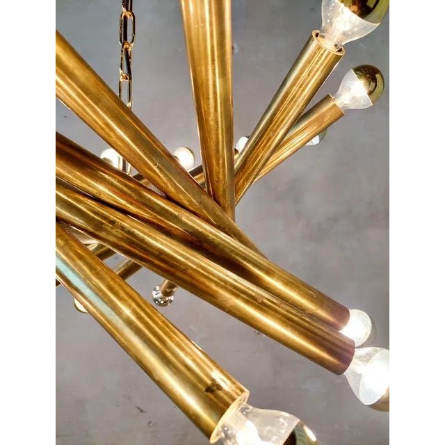 Pair of Mid-century Italian brass pendant lamps by Stilnovo from the 1950s. with 24 light points (E14) on a construction...