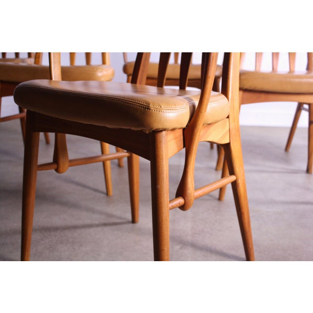 Sinuous sculpted curves with delicate supports carved from teak make up the back of these amazing dining chairs by...
