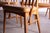 Sinuous sculpted curves with delicate supports carved from teak make up the back of these amazing dining chairs by...