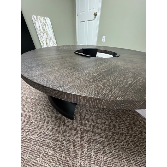 Retail for $7868. The Discus Cocktail Table expresses thoughtful modern design. A rolled bronze base softens its clean,...