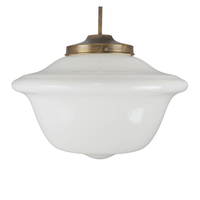 Schoolhouse pendant light made of an antique milk glass globe paired with a newly made brass pole fitter. This requires...