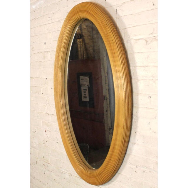 Large oval mirror with a thick bamboo style frame. Works great vertical and horizontal. Please confirm location with...
