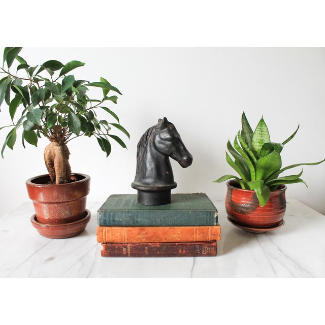 Antique cast-iron horse head hitching post topper featuring a collar or flared base designed to fit onto pole, or gate....