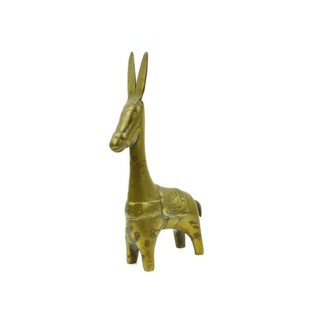 It's difficult to definitively categorize this figurine as a burro, llama, or Dhokra horse due to its stylized and...