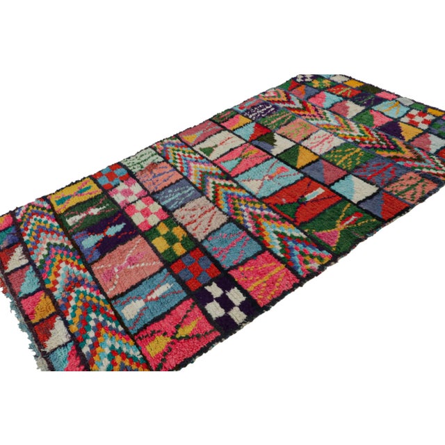 Hand-knotted in wool and circa 1950-1960, this 5x9 vintage Moroccan rug is believed to hail from the Azilal tribe. On the...