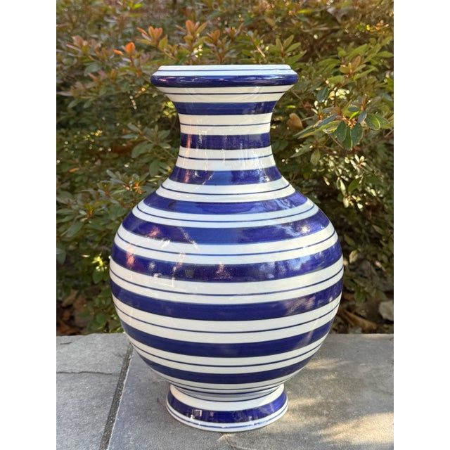 Lovely navy blue striped porcelain vase measuring 15” tall. Versatile piece with contemporary flair to add to any style...