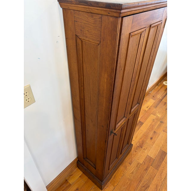 This is a very unique Antique Bench Made Oak Gun Cabinet with a picture framed panel door. It has 4 interior drawers for...