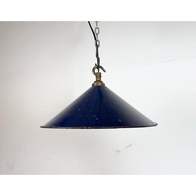 Industrial dark blue enamel factory pendant light made in United Kingdom during the 1950s. White enamel inside the shade....