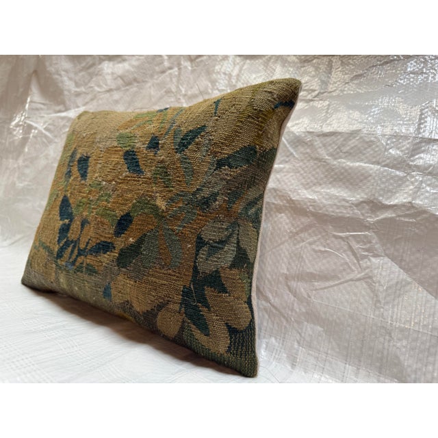 This decorative pillow is created from an authentic fragment of a 17th century Brussels tapestry, originating from one of...