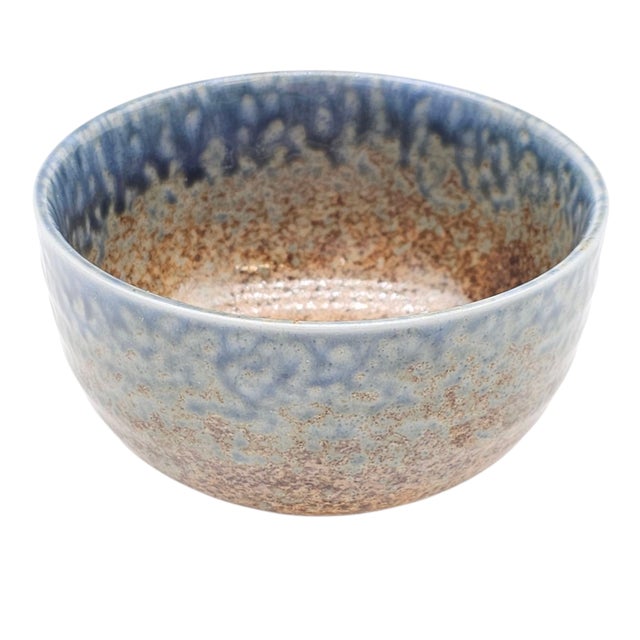 An expressive work of modern Japanese studio pottery, this hand-thrown bowl features a layered drip glaze blending celadon...