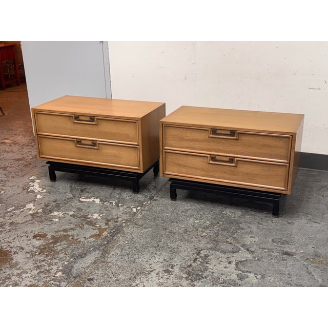 Design Plus Gallery presents a Pair of Blonde Walnut Nightstands by American of Martinsville from the Late 20th Century....