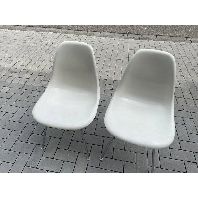 Beautiful Eames sidechair pair. The fiberglass shell is from Herman Miller/Vitra and sits on a classic H-base. Color is...