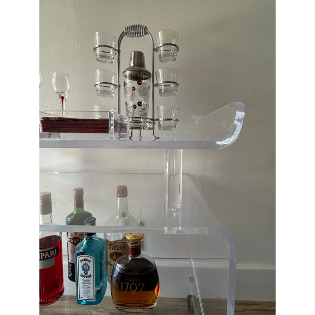 Super sexy, simply elegant, vintage acrylic cocktail bar cart. Chinoiserie, regency design in clear lucite with three...