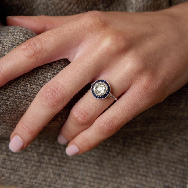 A bold and architectural engagement ring inspired by the glamour of the Art Deco era, this striking platinum design...