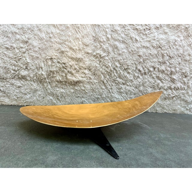 Vintage copper colored aluminum fruit bowl on a black footed base manufactured by Mirro, USA. Stamped is located on the...