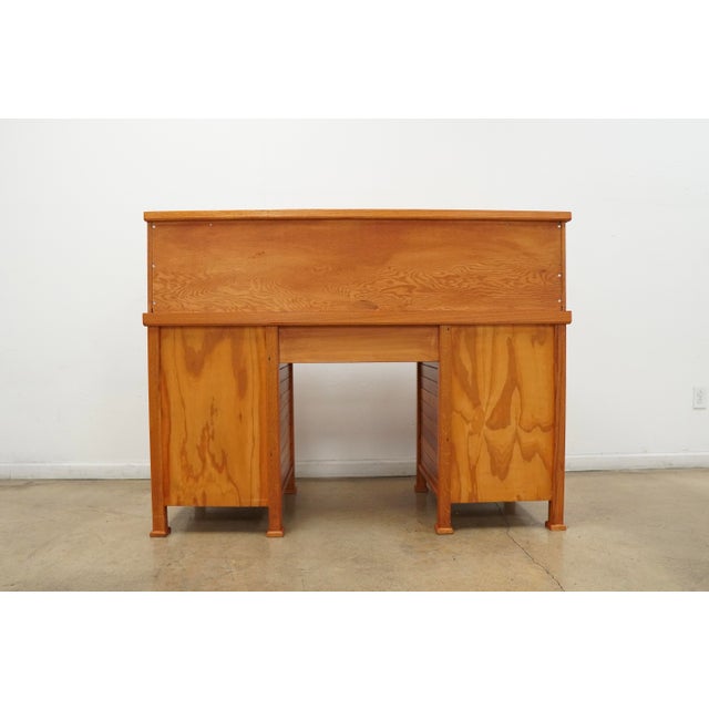 Vintage oak rolltop desk featuring a warm honey-toned finish, classic tambour front, and beautifully detailed wood grain...