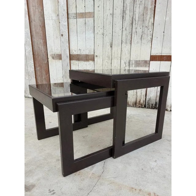 Vintage Nesting Tables with Smoked Glass - a charming pair from the 1960s that exude timeless elegance. This set of two...