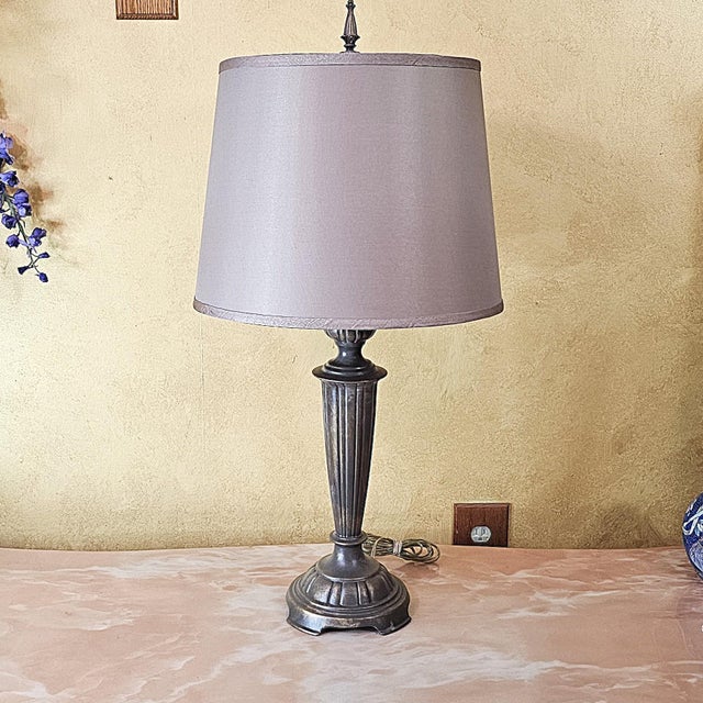 This tall vintage metal table lamp showcases a fluted column design inspired by classical architecture, resting on a...