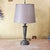 This tall vintage metal table lamp showcases a fluted column design inspired by classical architecture, resting on a...