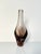 An elegant, sculptural glass vase made of heavy Bohemian smoked glass with a softly rounded, twisted silhouette and a...