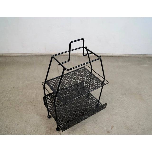 1950's Mid century Modern magazine rack for sale. It's really solid and well built, and is made of solid metal and solid...
