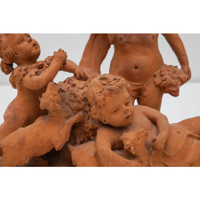 Beautiful in detail and charming 19th century unglazed terracotta sculpture. Features a design of three cherubic children...