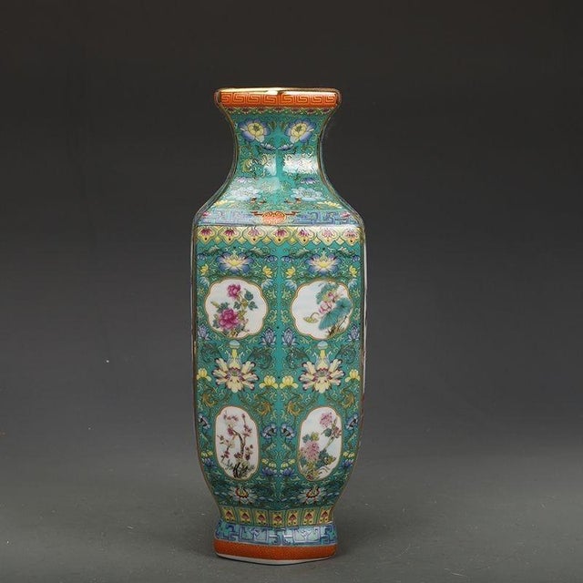 This elegant hexagonal porcelain vase features rich famille rose enamel work with a central panel depicting traditional...