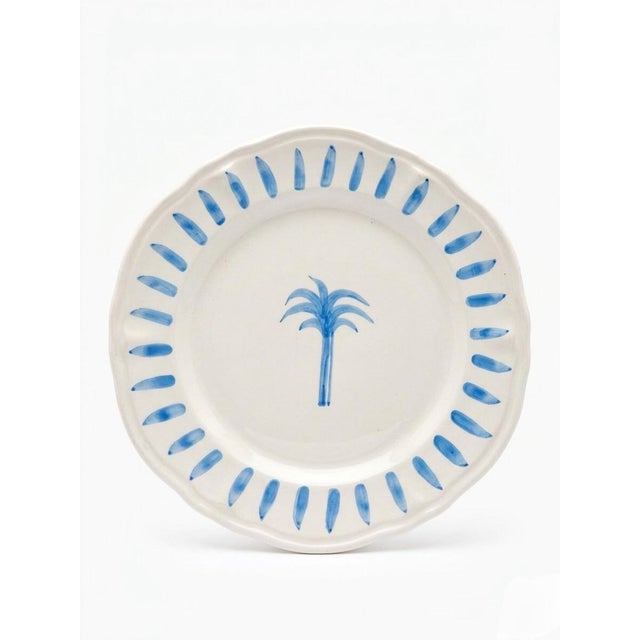 This charming pair of ceramic plates by Les-Ottomans captures a sophisticated coastal aesthetic with a playful, hand-...
