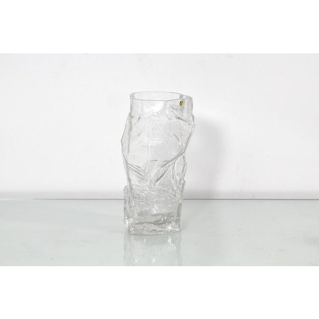 Beautiful and unusual thick and heavy 'glacier' clear glass vase, with an irregular shape, made by Peill & Putzler of...