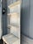 Charming vintage solid wood étagère with a tall, narrow profile and beautifully aged distressed cream finish. Features two...