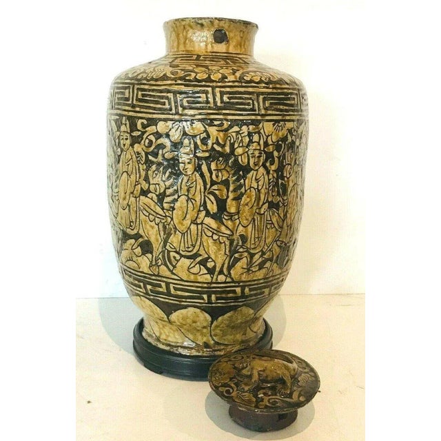 Covered vase in cracked earthenware Decorated with figures on horseback Black wooden base Small chips on the cabochon (see...